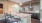 a clubhouse kitchen with a bar and a refrigerator