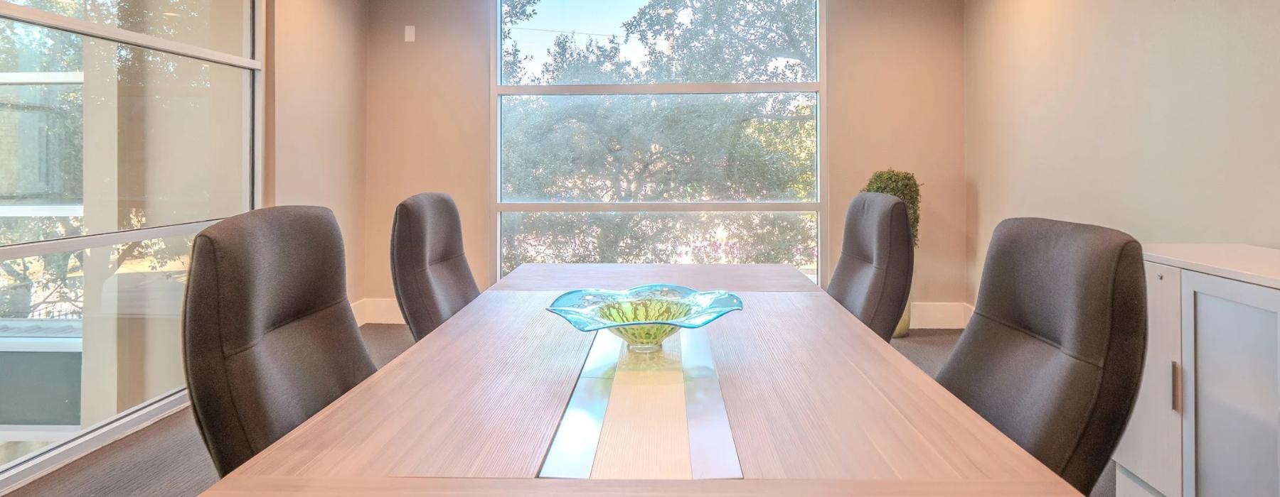 a conference room with a table and chairs