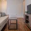 a living room with a white couch and a television